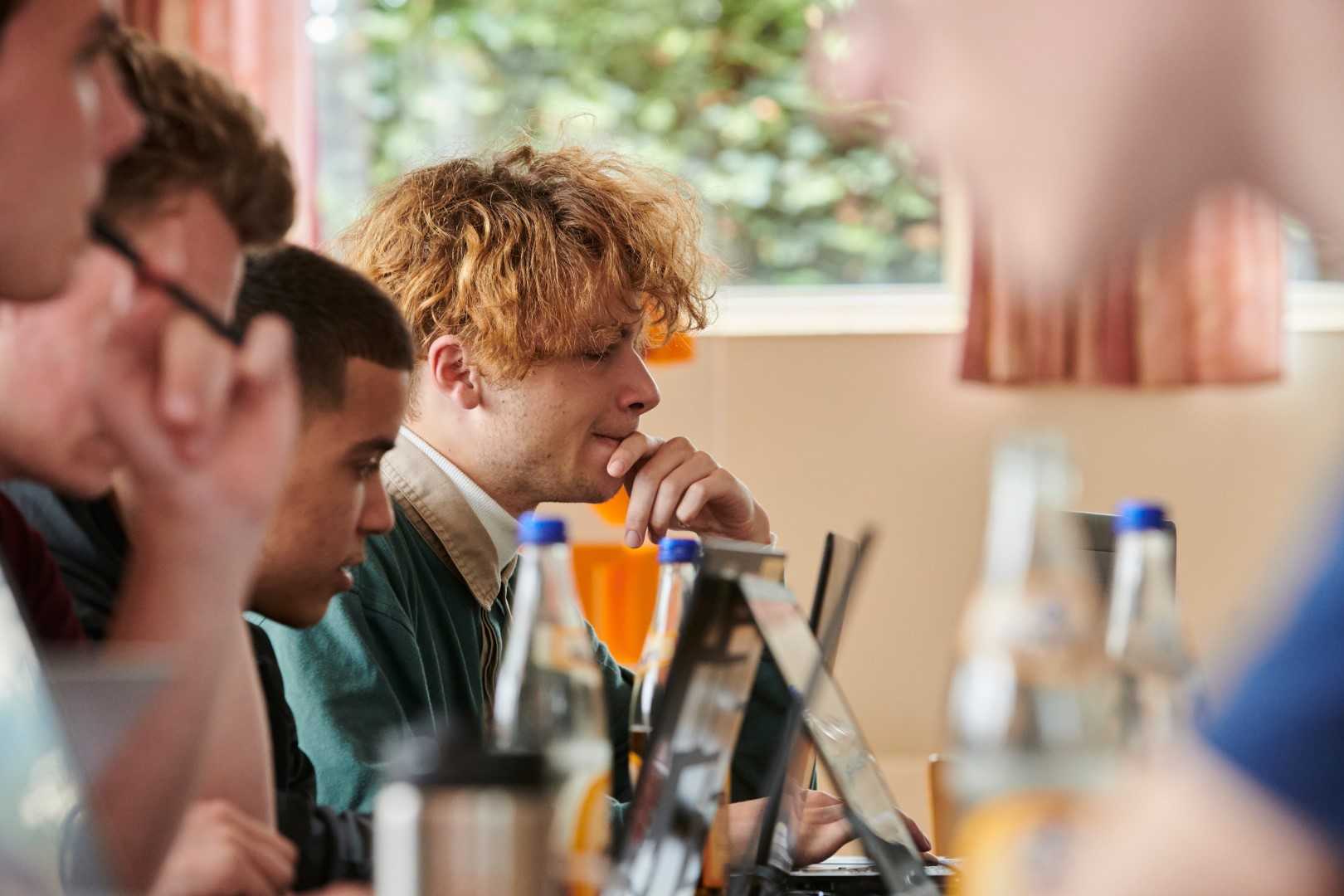 Hacker during the bootcamp looking at his laptop